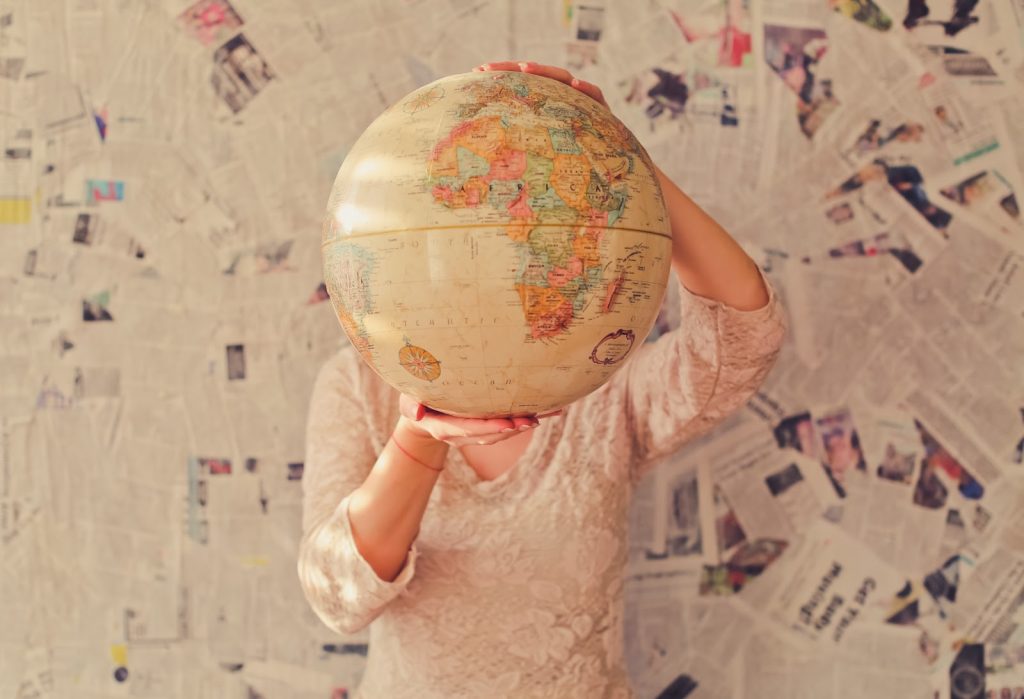 Person holding a globe